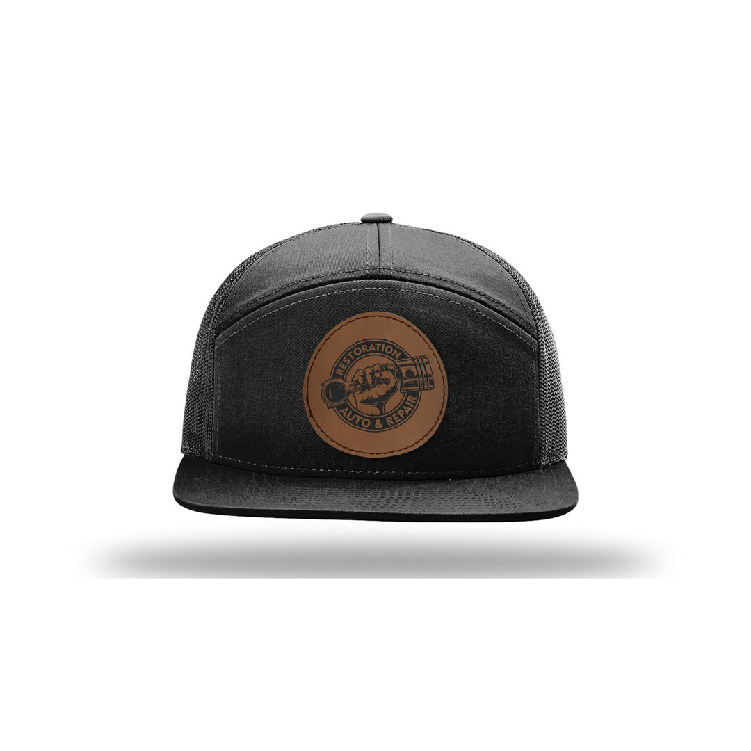 Richardson 168 7-Panel Trucker in Black with a custom leatherette logo patch