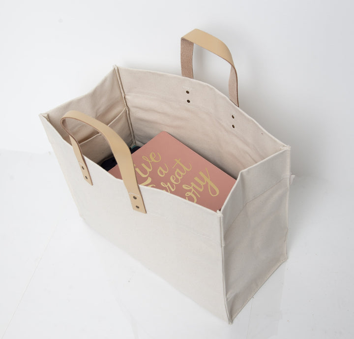 Natural canvas tote bag with wooden handles and custom printed red and gold design panel inside