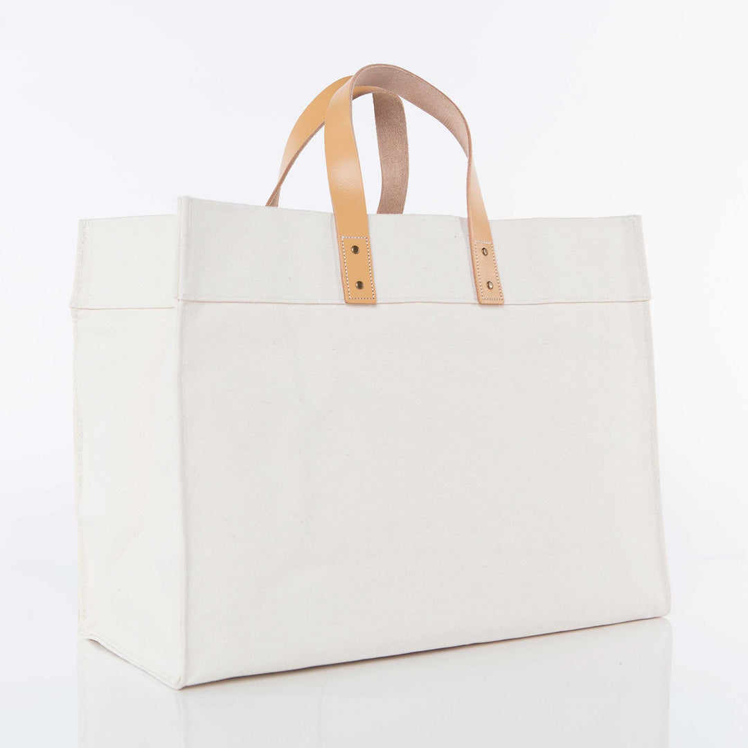 White canvas tote bag with tan leather handles and reinforced stitching, ready for custom branding or design.