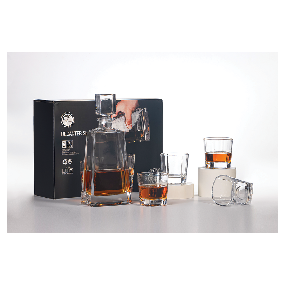 Black decanter set with square bottle, pourer top, and four drinking glasses filled with amber liquid, displayed with branded black box packaging.