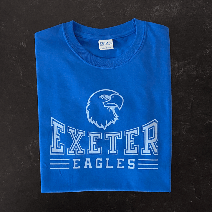 Royal blue t-shirt with white eagle head logo and "Exeter Eagles" text design across chest