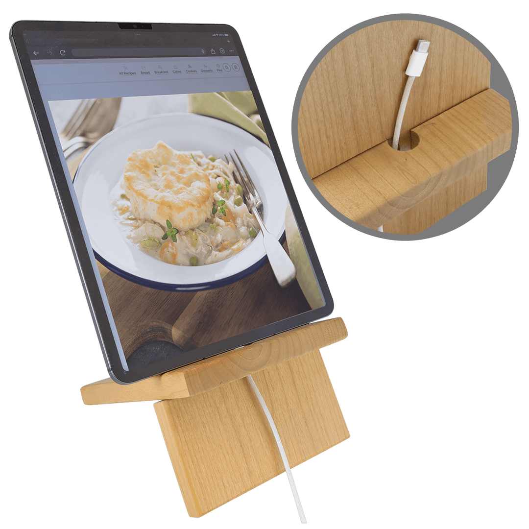Tablet charging on the large stand with the cord through the slot
