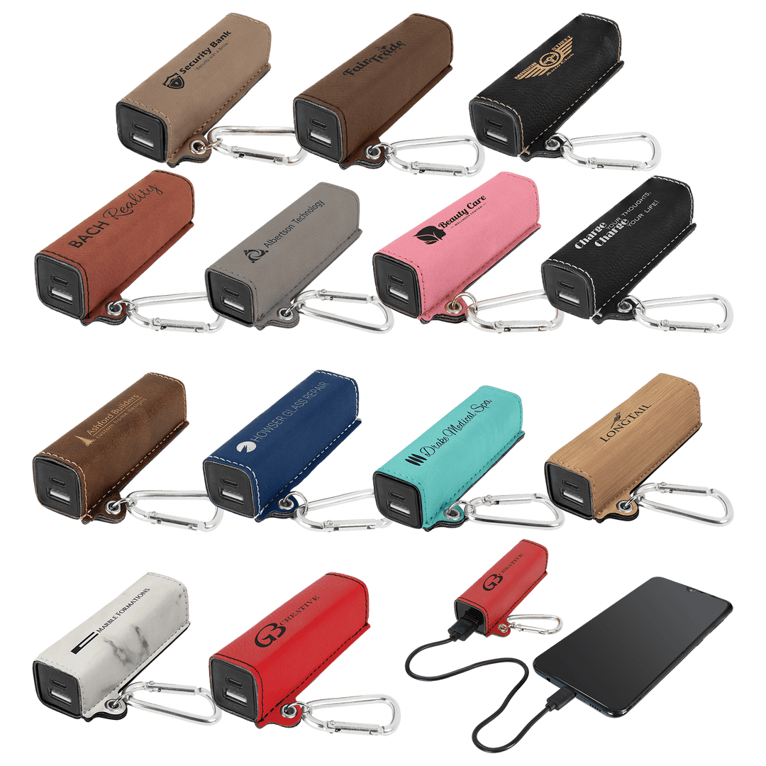 Leatherette power banks in 13 colors with sample engraved logos, one charging a phone