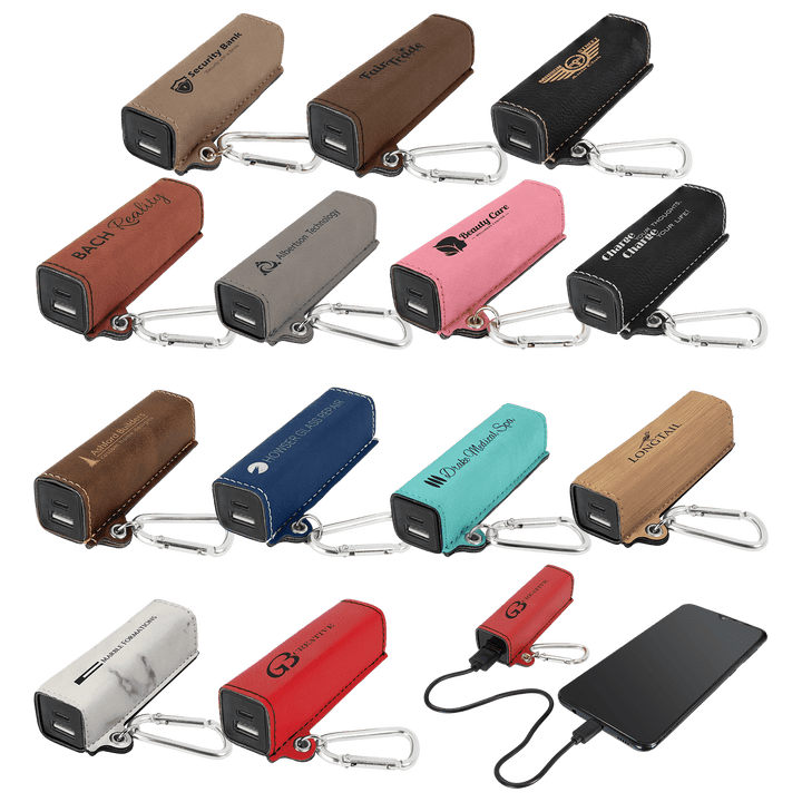 Leatherette power banks in 13 colors with sample engraved logos, one charging a phone