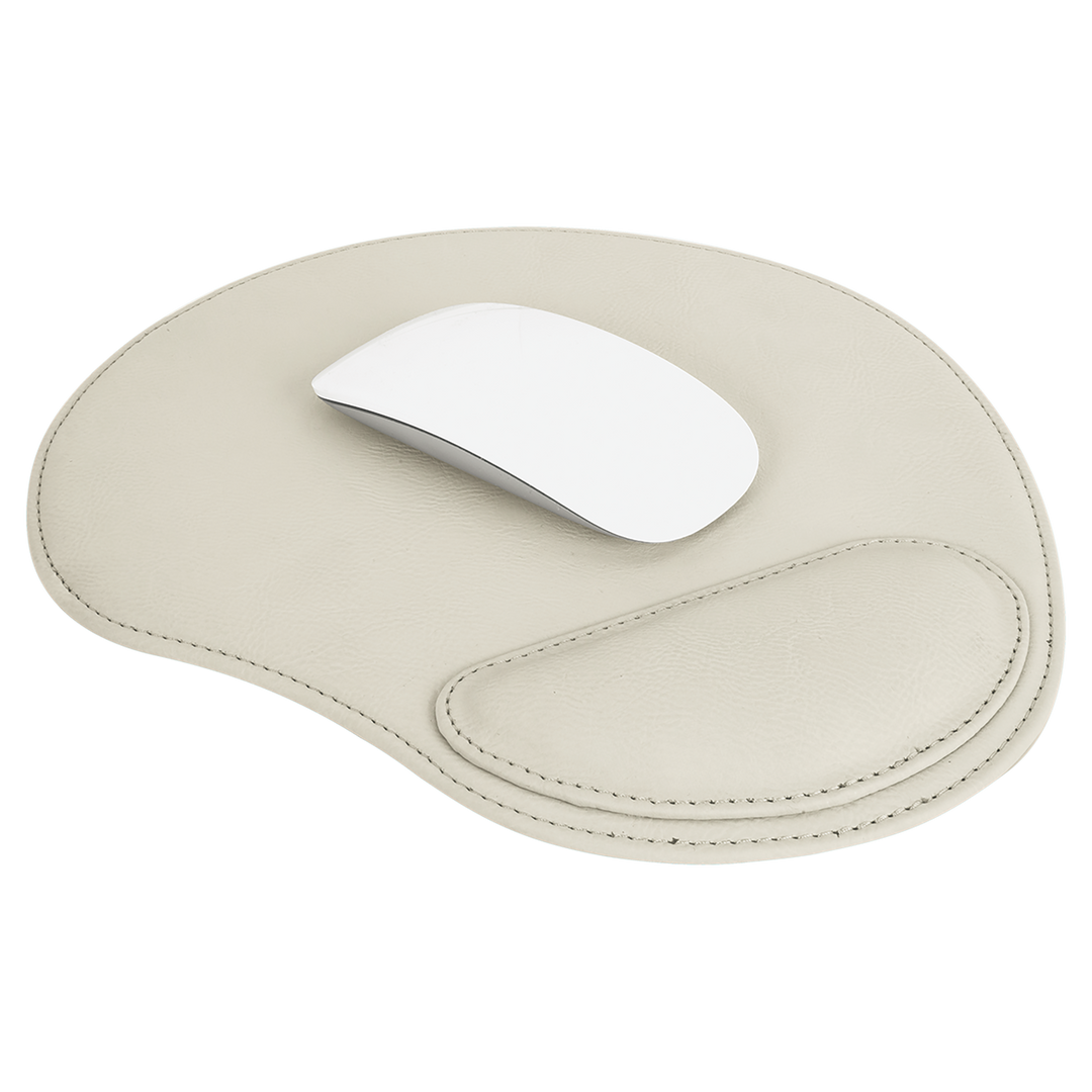 Cream leatherette mouse pad with ergonomic wrist rest and white mouse, featuring stitched details and custom engraving area.