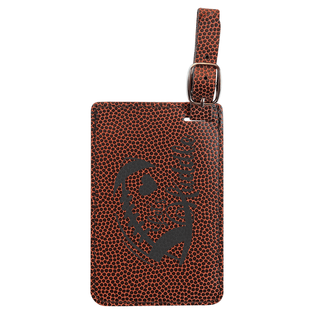 Brown pebbled leather luggage tag with gray skull design and metal buckle attachment loop.