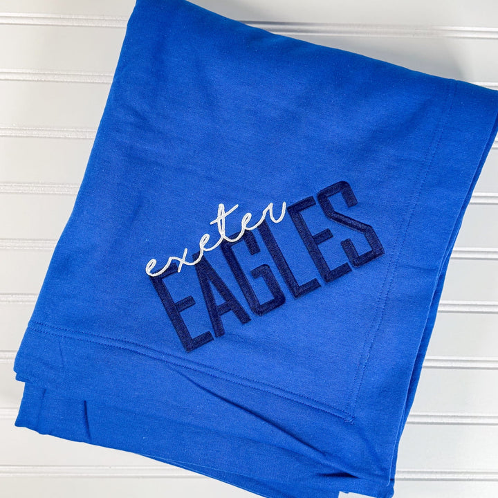 Royal blue fleece blanket with white and navy embroidered "exeter EAGLES" text