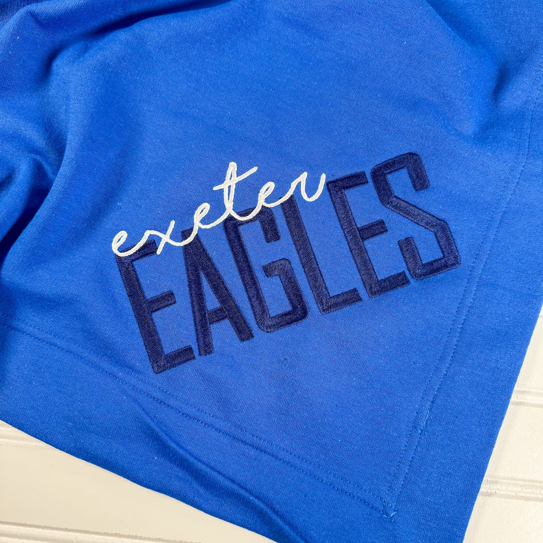 Royal blue fleece blanket with "exeter EAGLES" embroidered in white and navy text