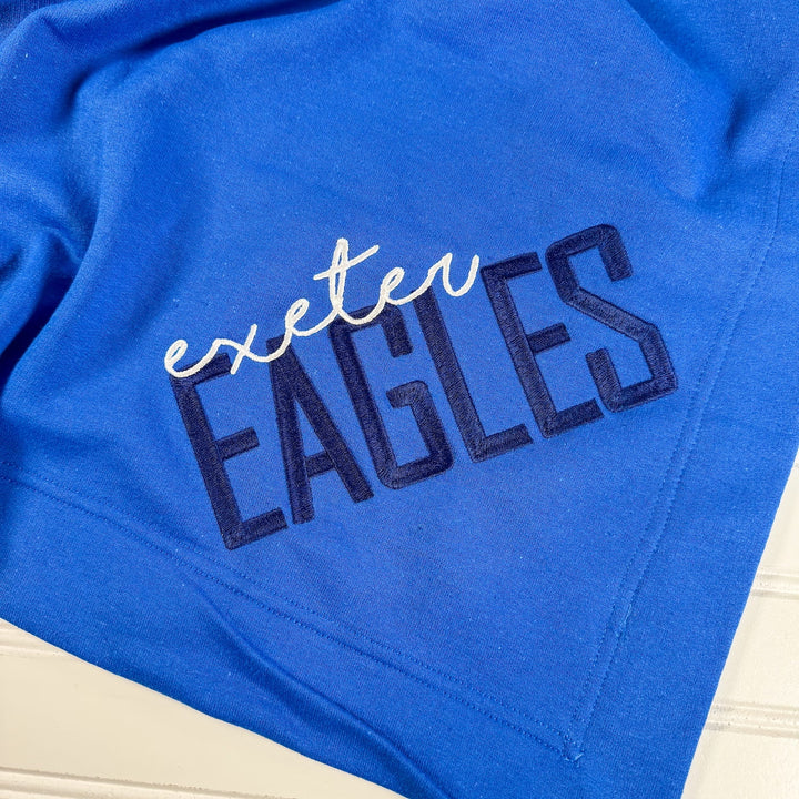 Royal blue fleece blanket with "exeter EAGLES" embroidered in white and navy text