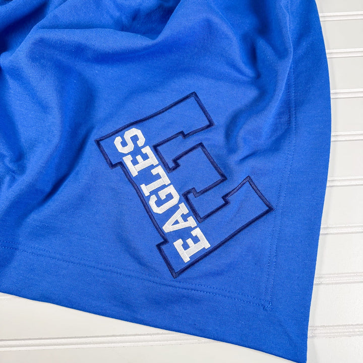 Royal blue fleece blanket with embroidered Exeter Eagles varsity letter design in white and navy outline.