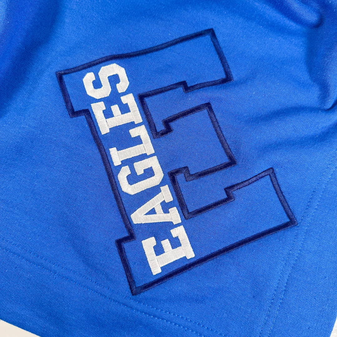 Royal blue fleece blanket with white "EAGLES" text and navy varsity letter E embroidered design