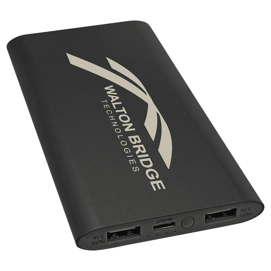 Black power bank engraved with a Walton Bridge Technologies logo, showing USB and USB-C ports