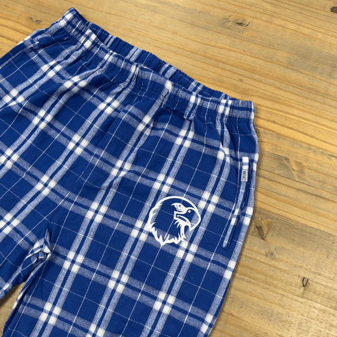 Blue and white plaid flannel pants with embroidered eagle head logo on thigh