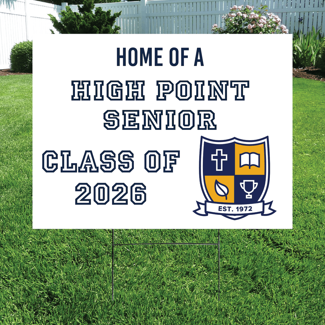 White yard sign with navy and gold High Point Senior class crest logo, "Home of a High Point Senior Class of 2026" text, displayed on grass lawn.