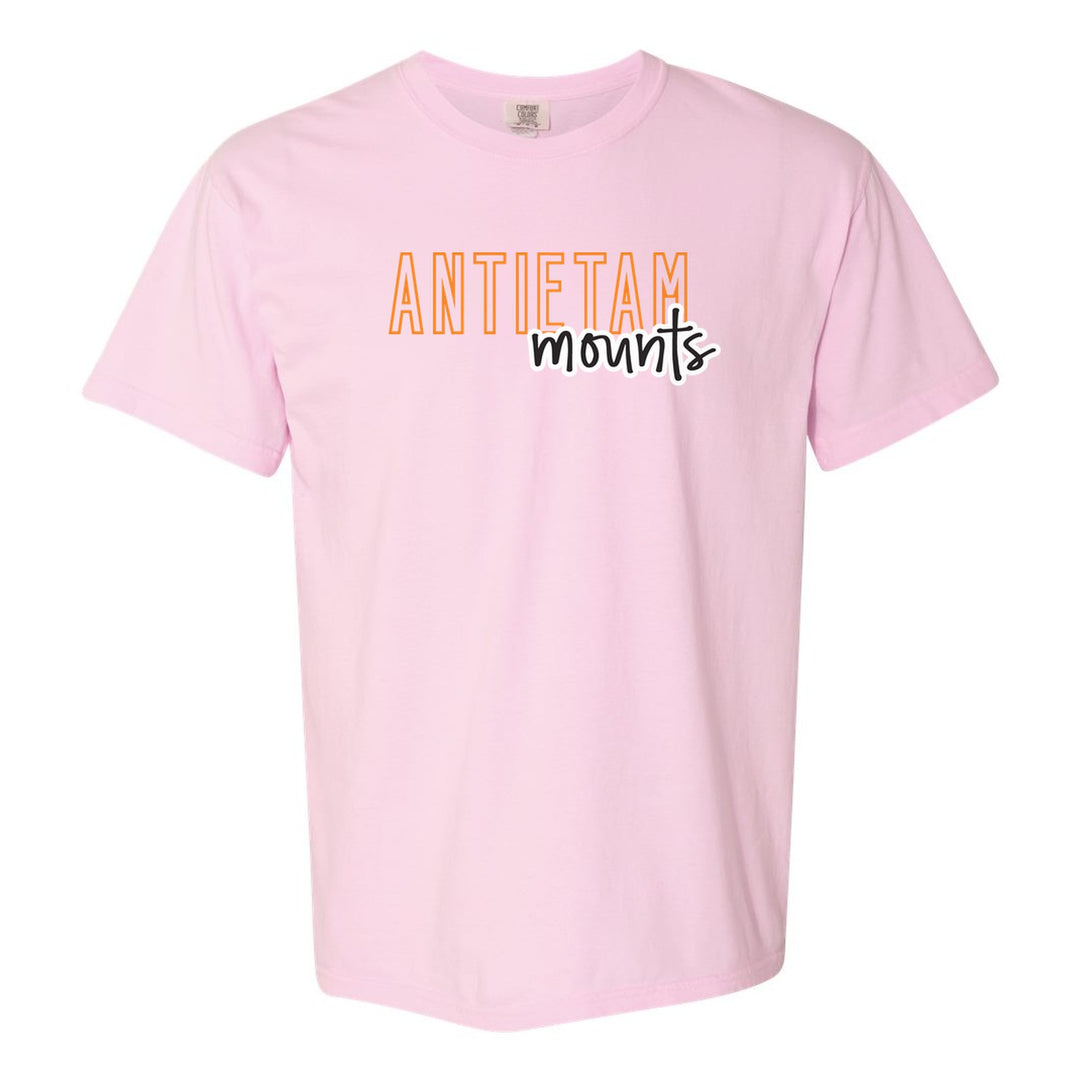 Antietam Mountaineers Outline Script comfort colors t-shirt in Blossom: outlined ANTIETAM letters with mounts script across the front