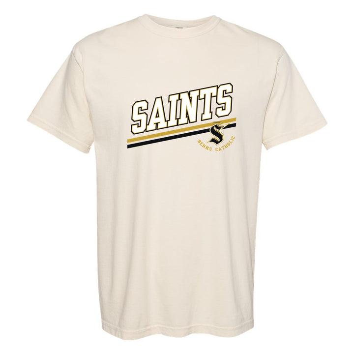 Berks Catholic Saints Slanted Stripe comfort colors t-shirt in Ivory: bold SAINTS lettering over a slanted double stripe, with the halo S and Berks Catholic