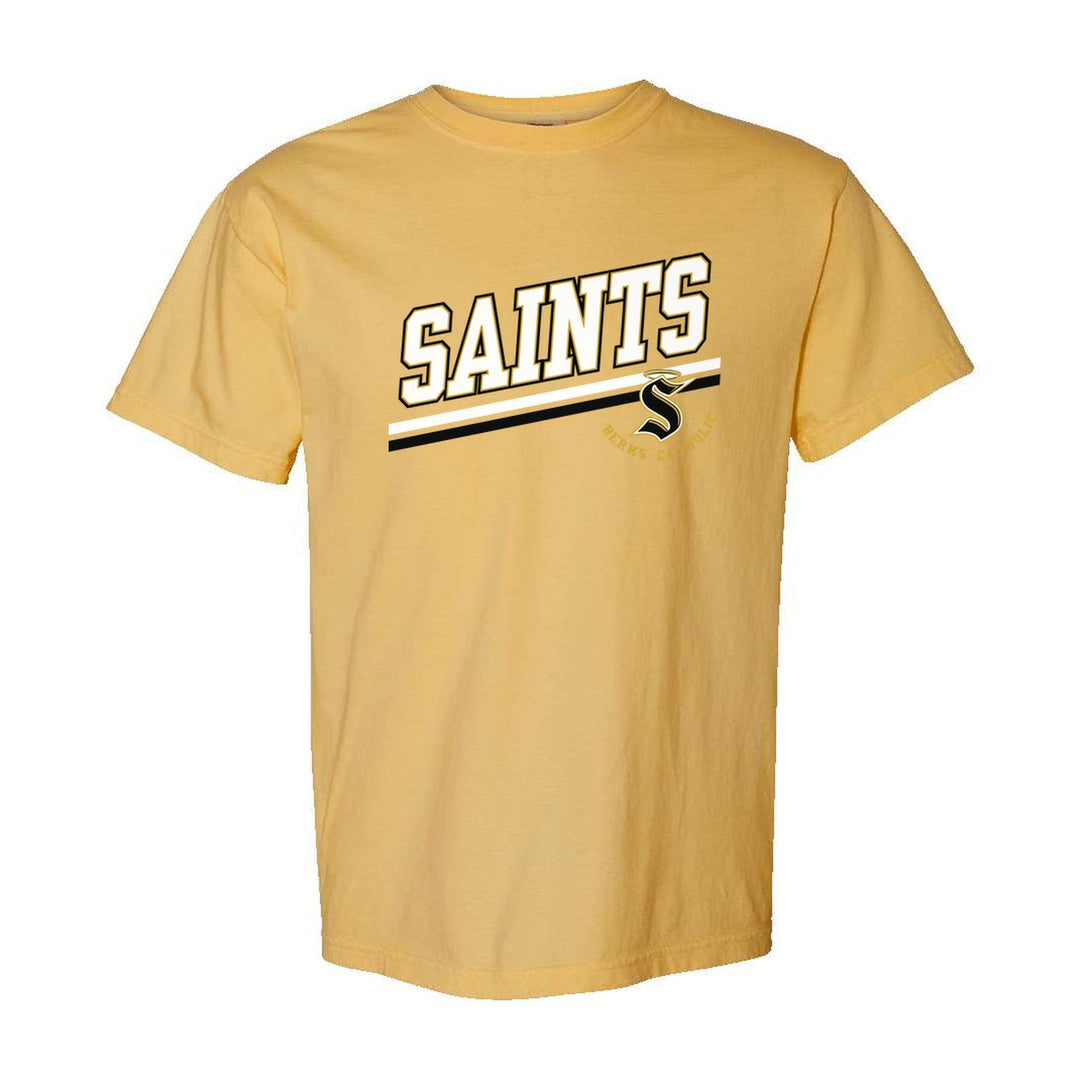Berks Catholic Saints Slanted Stripe comfort colors t-shirt in Mustard: bold SAINTS lettering over a slanted double stripe, with the halo S and Berks Catholic