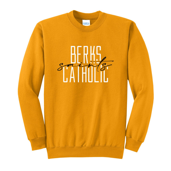 Berks Catholic Saints Tall Type Script crewneck sweatshirt in Gold: tall BERKS CATHOLIC lettering with saints in flowing script across the middle
