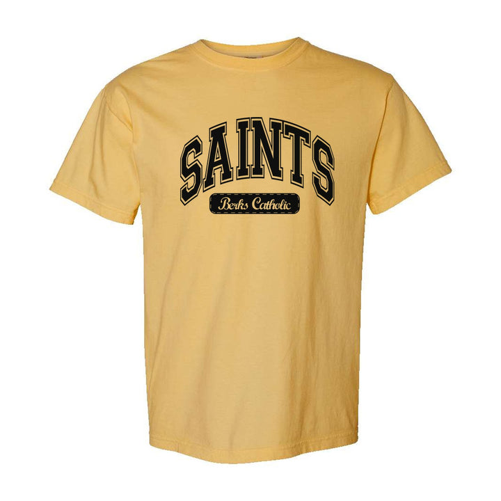 Berks Catholic Saints Varsity Arch comfort colors t-shirt in Mustard: arched varsity SAINTS lettering over a Berks Catholic badge