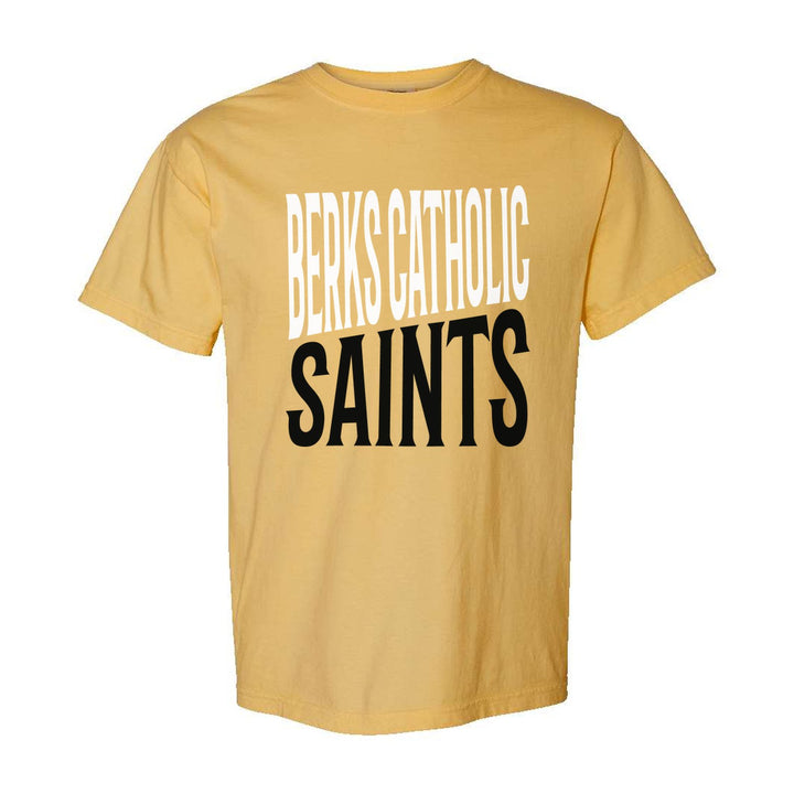Berks Catholic Saints Block Stack comfort colors t-shirt in Mustard: tall BERKS CATHOLIC stacked over SAINTS in condensed block letters