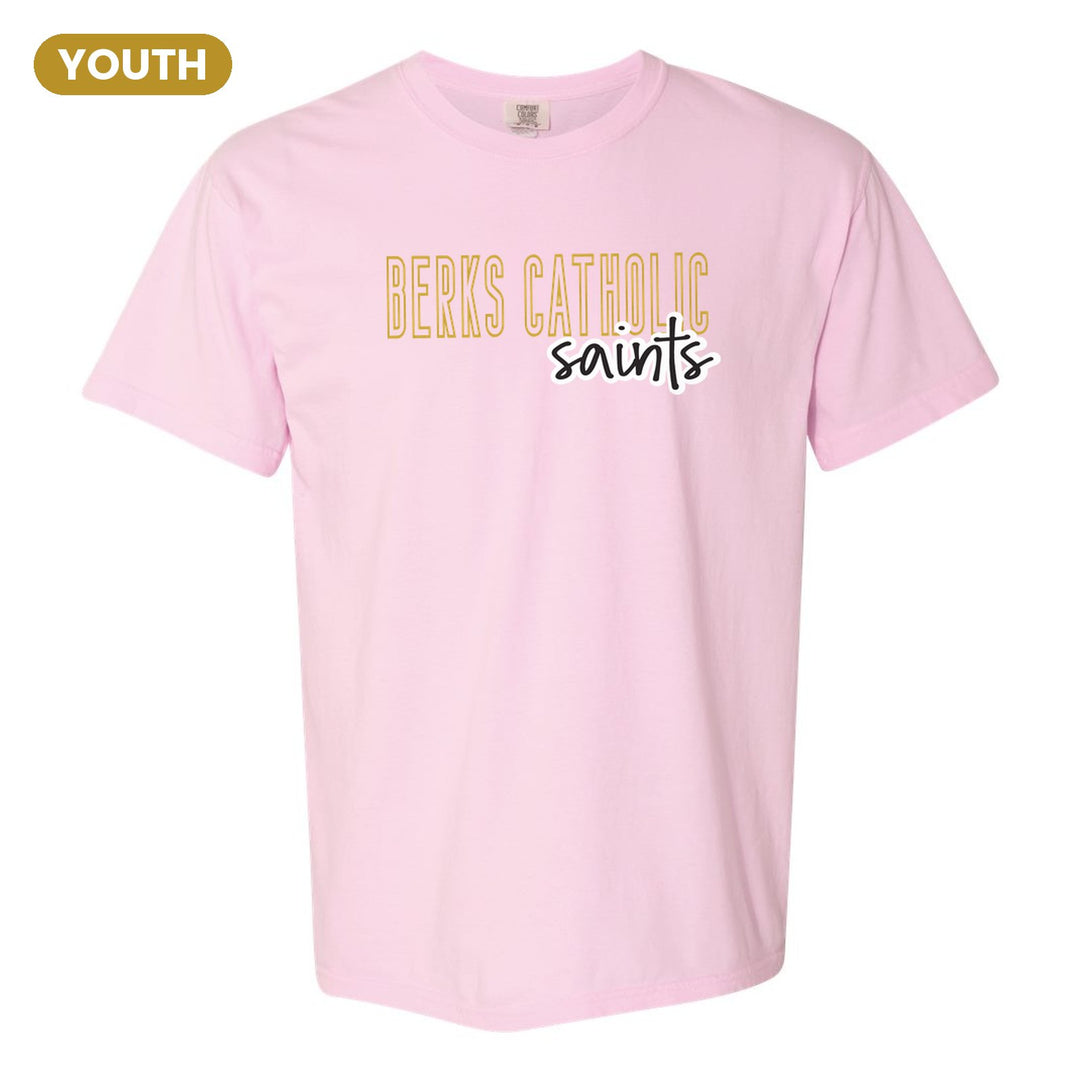 Berks Catholic Saints Outline Script youth comfort colors t-shirt in Blossom: outlined BERKS CATHOLIC letters with saints script across the front
