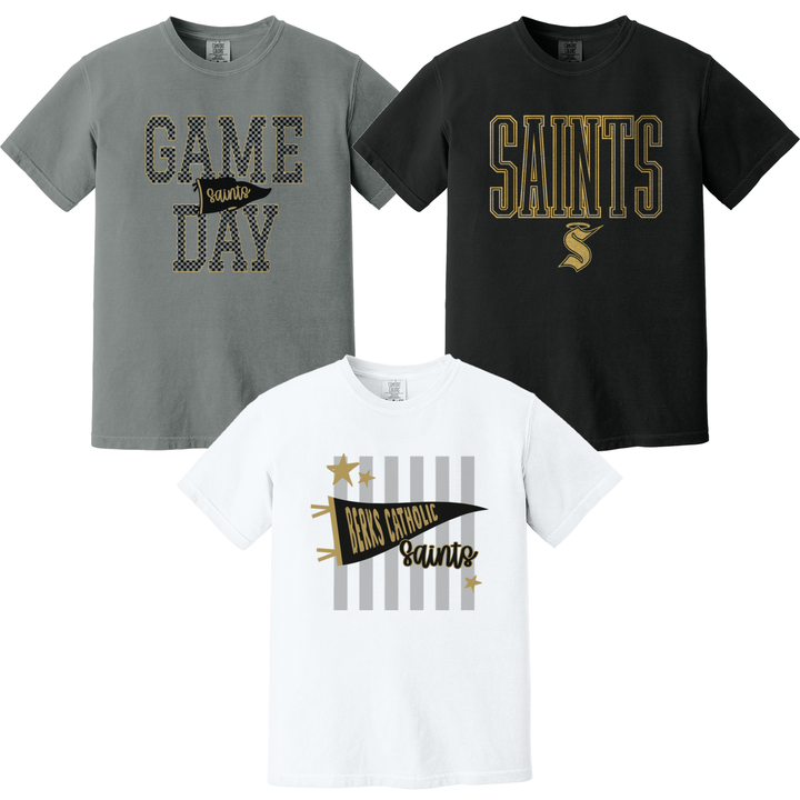 Berks Catholic Saints Comfort Colors tees in grey, white and black showing three of the fifteen designs