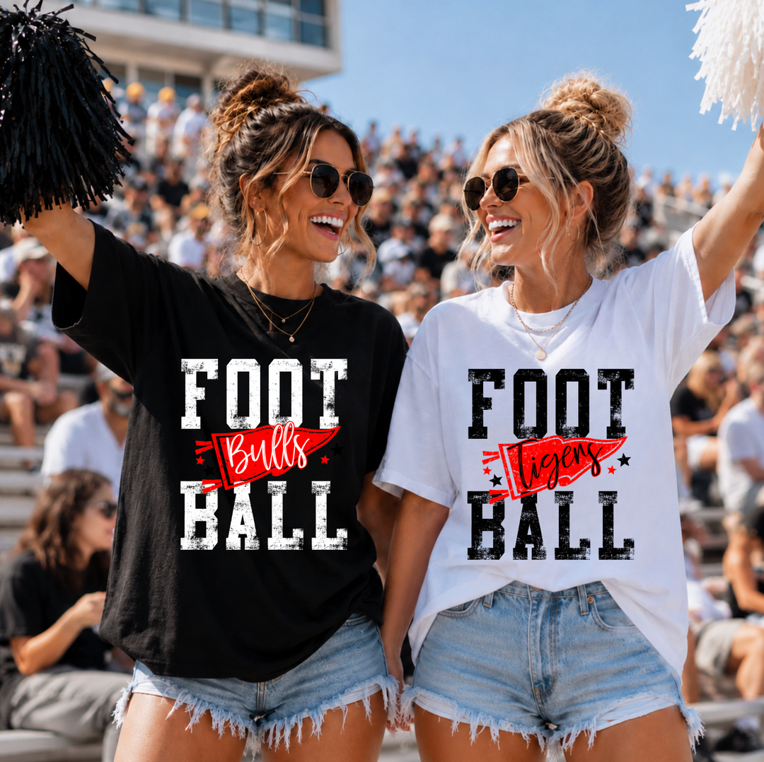 Two fans in the stands wearing football pennant t-shirts: black tee with a red Bulls pennant and white tee with a red Tigers pennant, distressed FOOTBALL lettering
