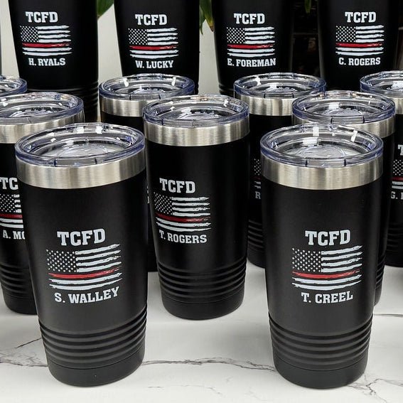 Black tumblers printed with a fire department logo and the Thin Red Line flag