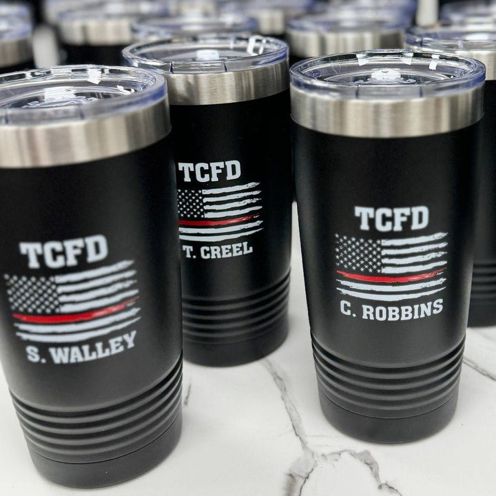 Black tumblers personalized with the Thin Red Line flag