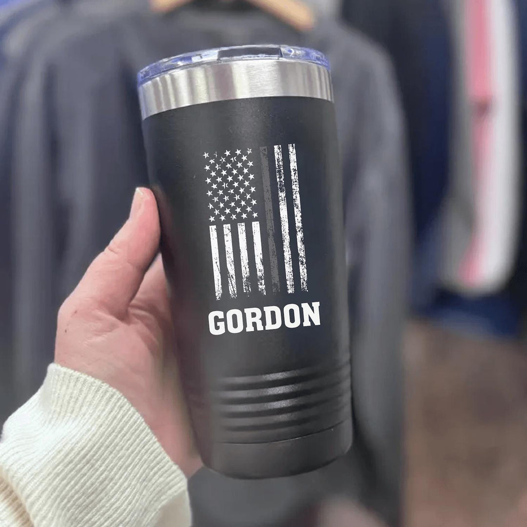 Black 20oz corrections officer tumbler printed in white with a distressed American flag, a grey line stripe and the name GORDON