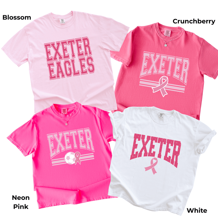 Four Exeter Pink Out t-shirts on garment-dyed Comfort Colors in blossom, crunchberry, neon pink and white, each with a different EXETER design in pink, three of them with a pink awareness ribbon