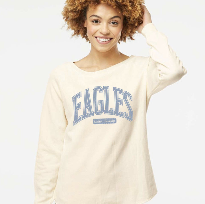 Model wearing the Exeter Eagles wave wash crew in Bone with the arched EAGLES varsity design